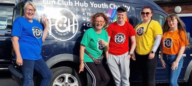Fun Club Hub volunteers posing in front of youth club van