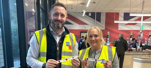 Poppy volunteers posing with Royal British Legion fundraising items
