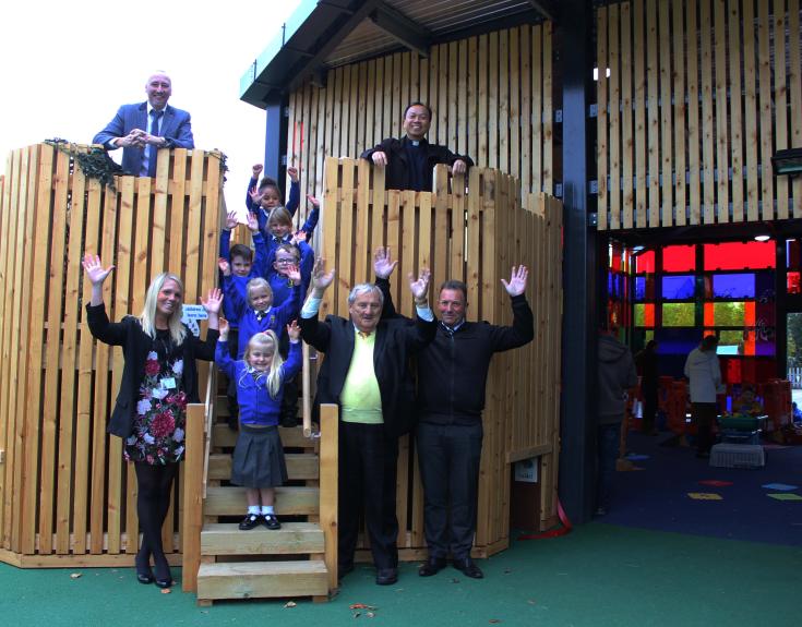 Noel Sweeney in group photo with staff and children at local primary school.